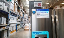 A fridge on sale in a home improvement store, displayed an energy star logo.