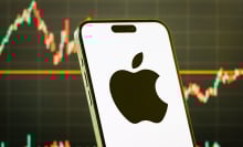 apple logo in front of a stock chart