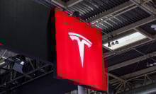 tesla logo high up in a conference room