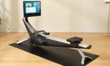 the Hydrow Arc rower on a black mat in a living room