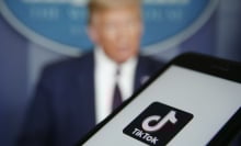 TikTok logo on mobile device and Donald Trump