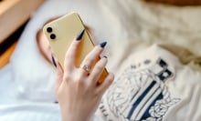 A teenage girl looks at her phone.