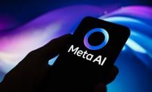 A hand holding a phone with the Meta AI logo.