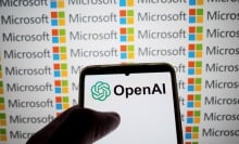  OpenAI logo appears on a smartphone screen and the Microsoft logo on a laptop screen 