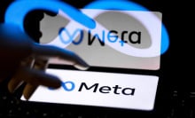A hand hovers over a screen showing the Meta logo. The image is reflected and distorted.
