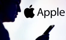 Apple logo behind man's silhouette