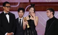 Ejae accepts award at Golden Globes.