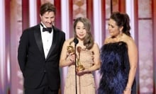 Chris Appelhans, Maggie Kang, and Michelle Wong speak onstage during the Golden Globe Awards.