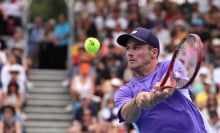 Tommy Paul hits a return in the Australian Open