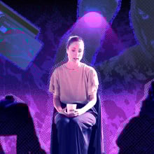 Woman sits in front of people listening empathetically.