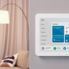 an amazon echo hub on a white wall inside of a home. it displays the time, lights, ceiling fan, vacuum, locks, and more