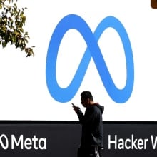 A man walks by Meta headquarters in Menlo Park, California.