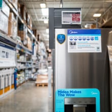 A fridge on sale in a home improvement store, displayed an energy star logo.