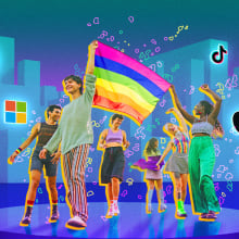 A group of people waving a Pride flag, with tech companies logos in the background.