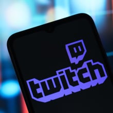 The Twitch logo is seen displayed on a smartphone screen.