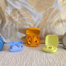 The Beats Studio Pro, Beats Fit Pro, Beats Solo 4, Beats Solo Buds, and Beats Powerbeats Pro 2 next to each other on a sofa.