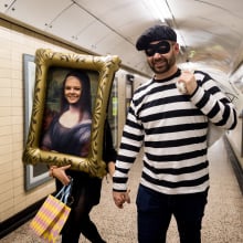 A couple in the Louvre heist Halloween costumes walk through the London Underground on October 31, 2025 in London, England. Halloween is widely celebrated across the UK with revellers dressing up for the occasion. Consumer spending on Halloween is forecast to rise 3.2% this year to about £537m.