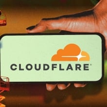 Cloudflare logo on phone screen with construction site background