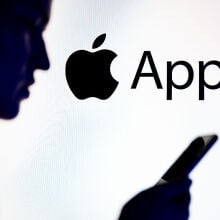 Apple logo behind man's silhouette