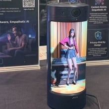 Holodeck of 3D-generated woman in a small tublar object.