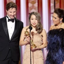 Chris Appelhans, Maggie Kang, and Michelle Wong speak onstage during the Golden Globe Awards.