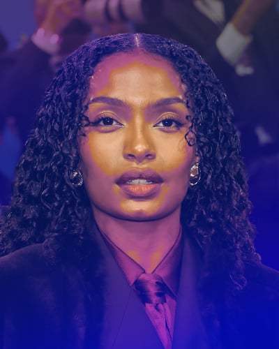 Shahidi stands in busy Times Square with her fist raised, posed in front of a large billboard advertising her podcast, the Optimist Project. 