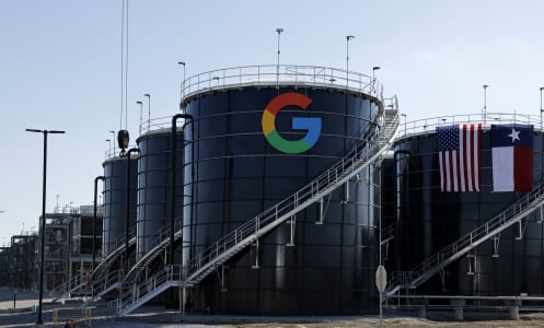 Two large metal structures emblazoned with the Google logo and the Texas state flag. 