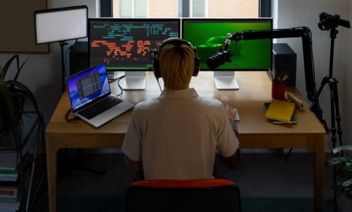 a person editing video at a mac screen