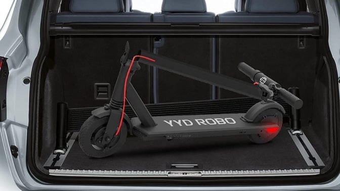 Black folded scooter in the trunk of a car