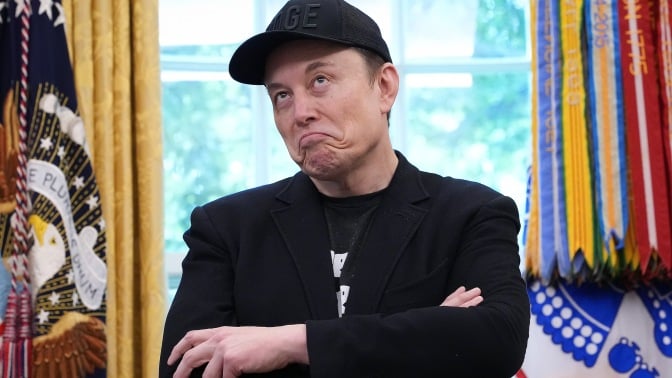 Elon Musk appears in the Oval Office wearing a Doge hat