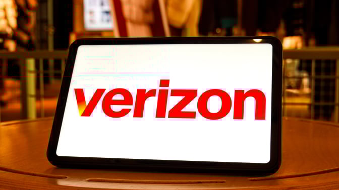 In this photo illustration, the logo of Verizon is seen displayed on the screen of a tablet