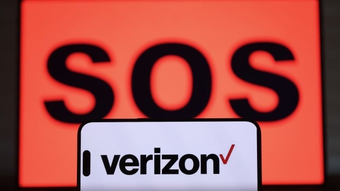 the verizon app appears on a phone screen in front of a large display that reads 'SOS'