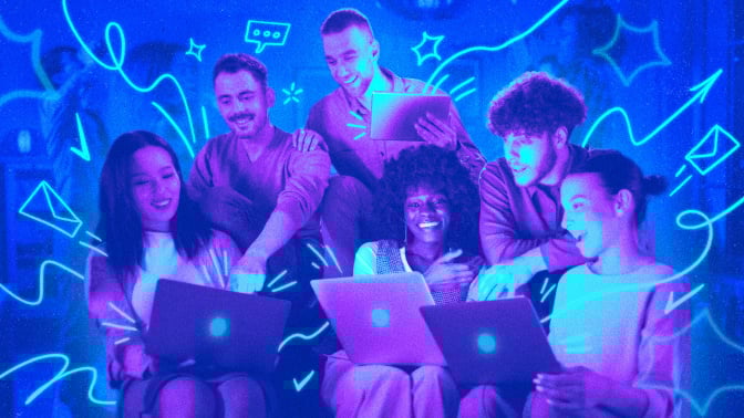 A group of people on their laptops, working together 