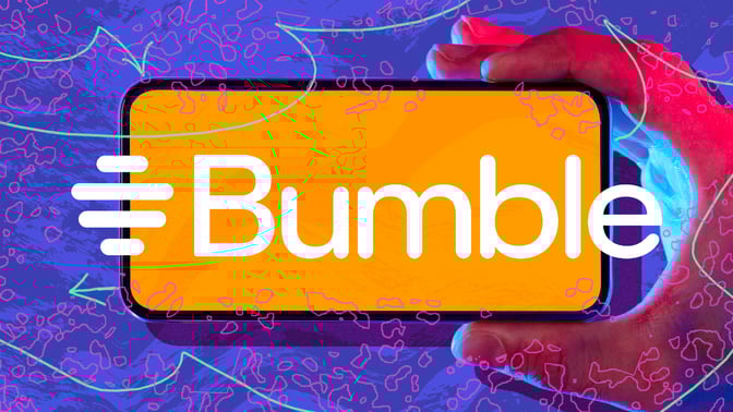 hand holding phone with bumble logo