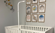 tall scope-like baby monitor looking over crib
