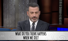 A man in a suit sits on a talk show. A question on the screen reads, "What do you think happens when we die?"