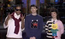 Two men and a woman stand facing the camera.