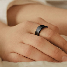 A person's hand wearing a black Samsung Galaxy Ring.