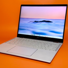 the Acer Chromebook Plus Spin 514 against an orange background