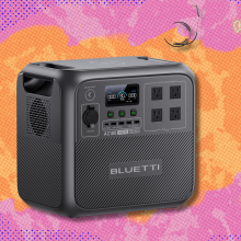 Bluetti AC180 Portable Power Station on orange and pink abstract background