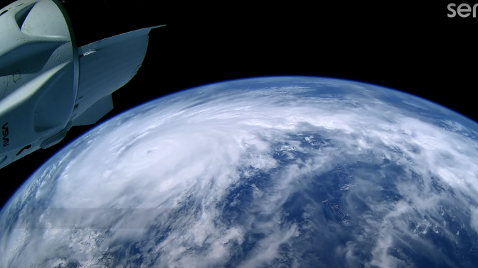 Planet Earth is seen from space, with a large storm visible.