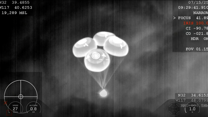 A thermal image of the SpaceX Dragon "Grace" capsule descending with four parachutes.