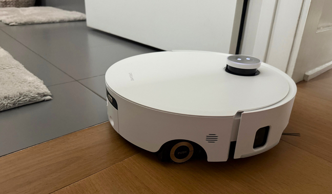 Dreame Aqua10 Ultra Roller robot vacuum mopping hardwood and tile floor in doorway